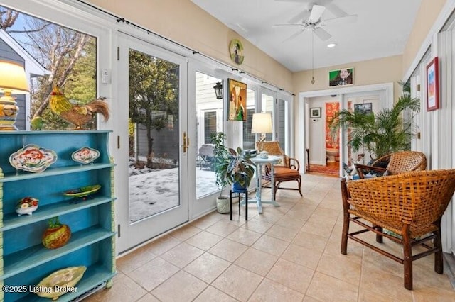 sunroom / solarium featuring ceiling fan