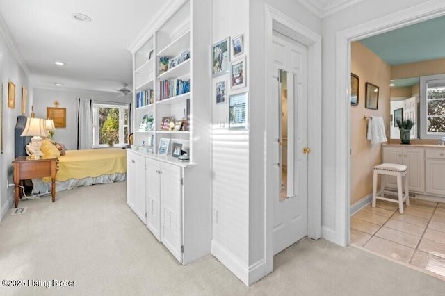 hallway with light carpet and crown molding