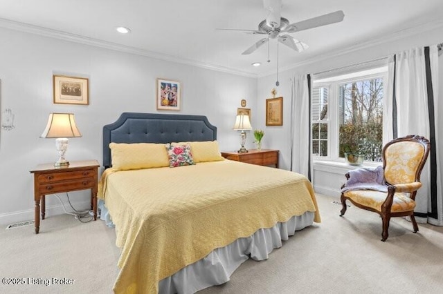 carpeted bedroom with ornamental molding and ceiling fan