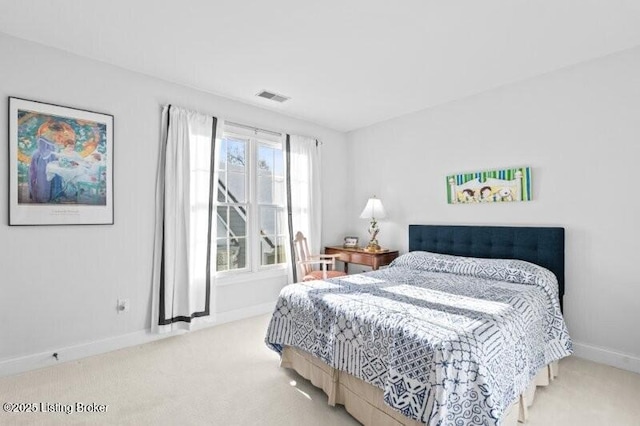 carpeted bedroom with visible vents and baseboards