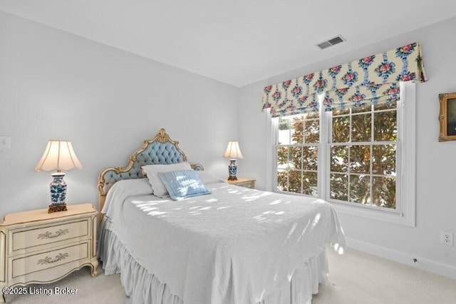 bedroom featuring visible vents, light colored carpet, and baseboards