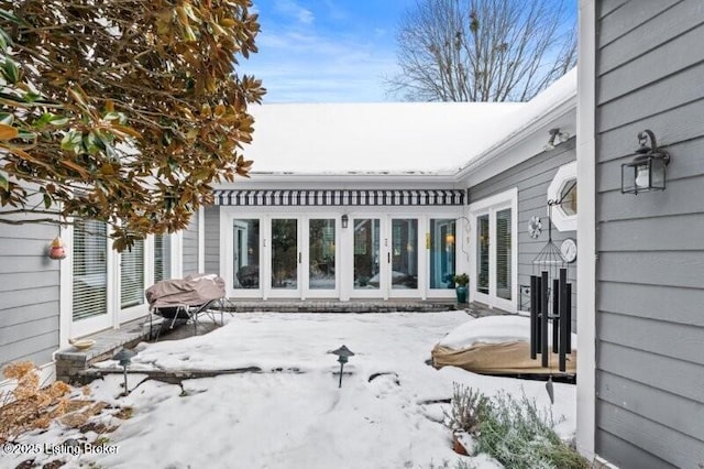 view of snow covered back of property