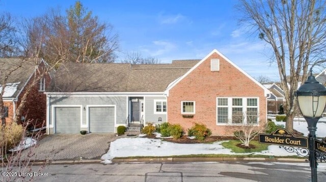 view of front of property with aphalt driveway, brick siding, and an attached garage