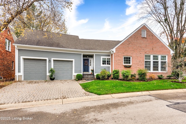 view of front of property featuring a garage and a front lawn