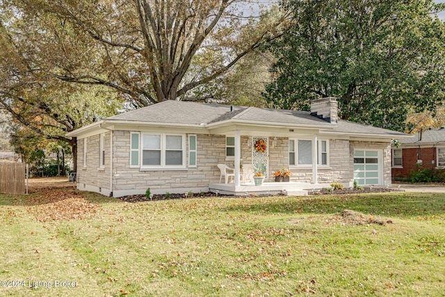 view of front of property with a garage and a front lawn