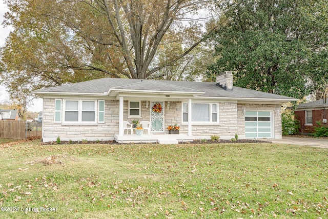 ranch-style house with covered porch, a garage, and a front lawn