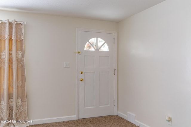 view of carpeted foyer