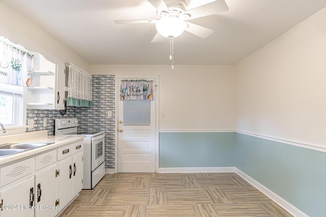 kitchen with sink, white cabinetry, white range with electric stovetop, and ceiling fan