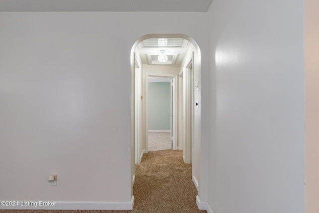 hallway featuring light colored carpet