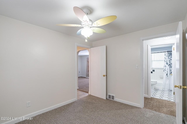 unfurnished bedroom featuring ceiling fan and light carpet