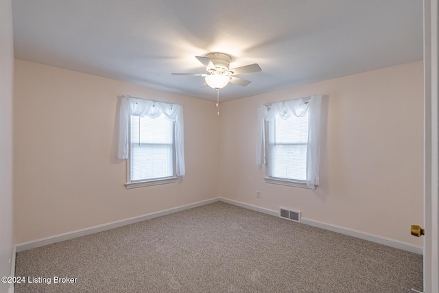 spare room featuring carpet flooring and ceiling fan