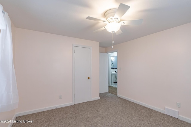 unfurnished bedroom with ceiling fan and carpet