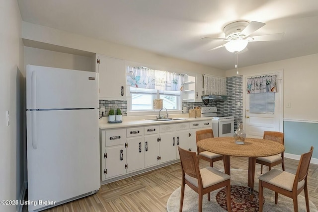 kitchen featuring sink, white cabinetry, white appliances, and decorative backsplash