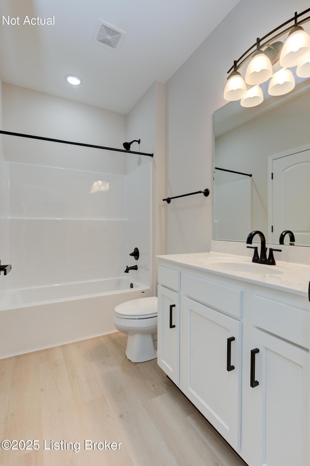 bathroom with shower / tub combination, toilet, wood finished floors, vanity, and visible vents