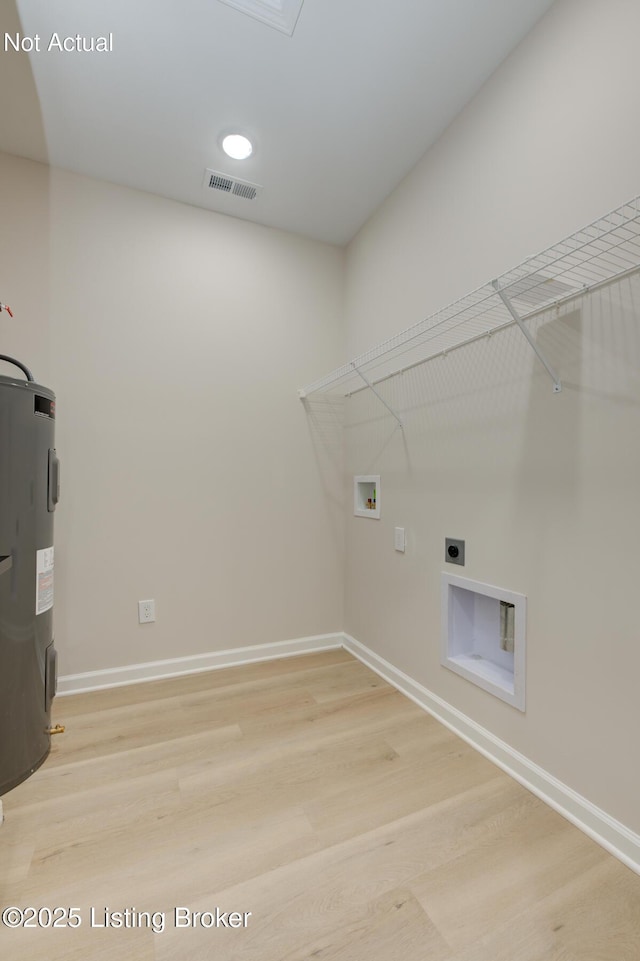 washroom featuring washer hookup, visible vents, water heater, wood finished floors, and laundry area