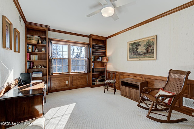 carpeted office featuring crown molding and ceiling fan