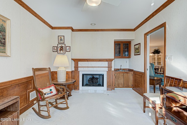 carpeted living room with crown molding and ceiling fan