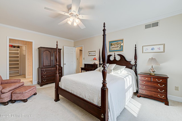 carpeted bedroom with ornamental molding and ceiling fan