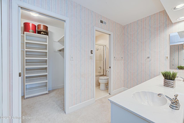 full bathroom with vanity, toilet, and combined bath / shower with glass door