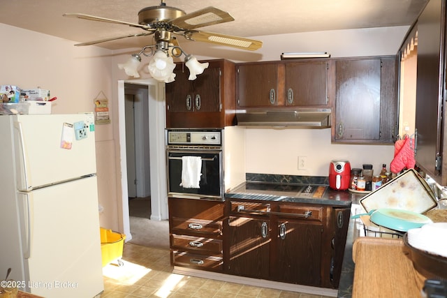 kitchen featuring stovetop, ceiling fan, dark brown cabinets, wall oven, and white fridge