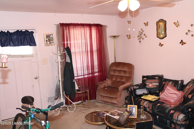 living room featuring ceiling fan and carpet