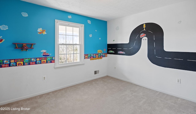 carpeted spare room with a textured ceiling