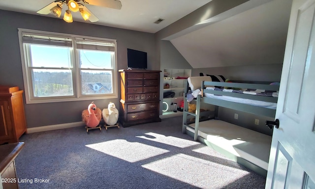 bedroom featuring lofted ceiling, dark carpet, and ceiling fan