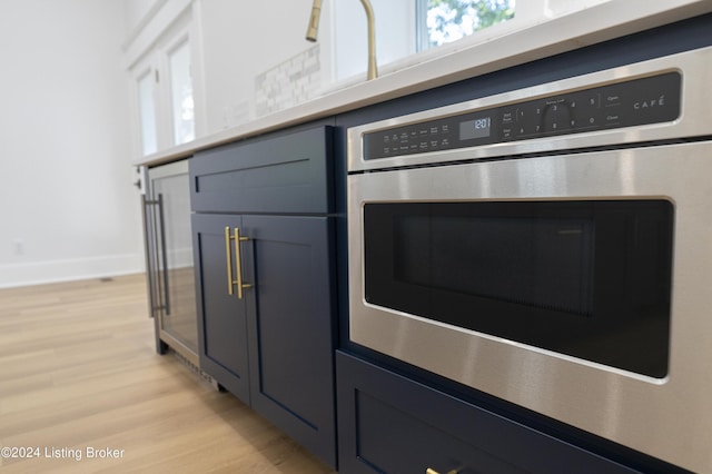 interior details with stainless steel oven and light wood-type flooring