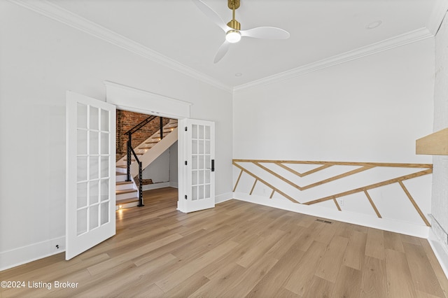 spare room with ornamental molding, french doors, ceiling fan, and light wood-type flooring