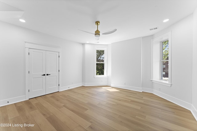 spare room with ceiling fan and light wood-type flooring