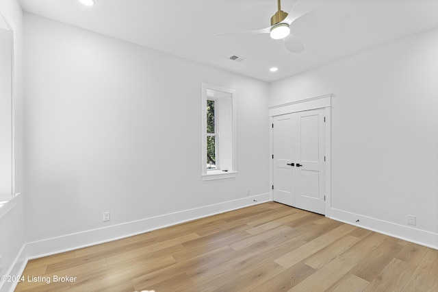 unfurnished room with ceiling fan and light wood-type flooring