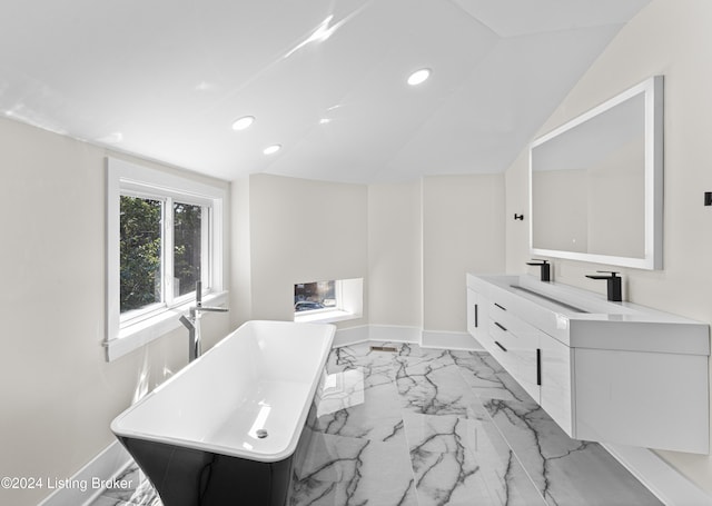 bathroom with vanity and a washtub