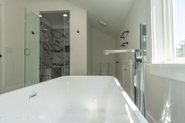 bathroom with independent shower and bath, vaulted ceiling, and toilet