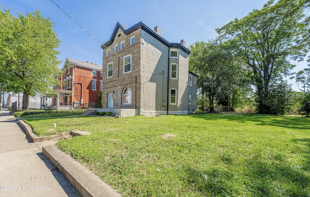 view of property exterior featuring a lawn