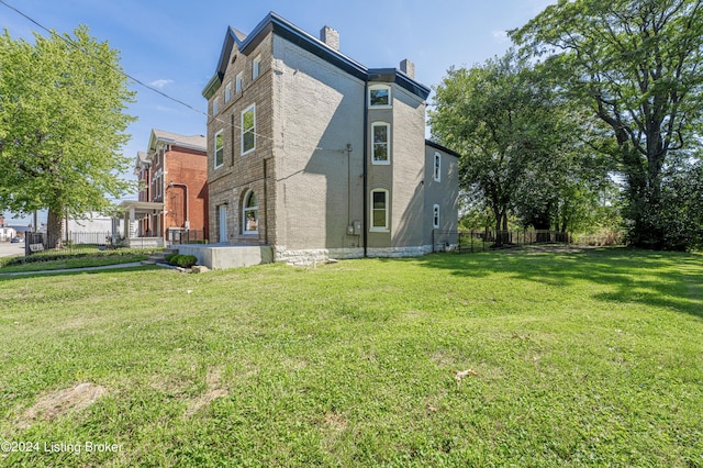 view of side of home featuring a yard