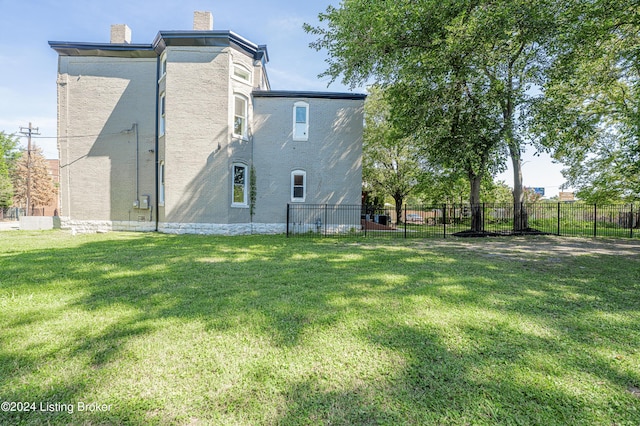 rear view of property featuring a yard