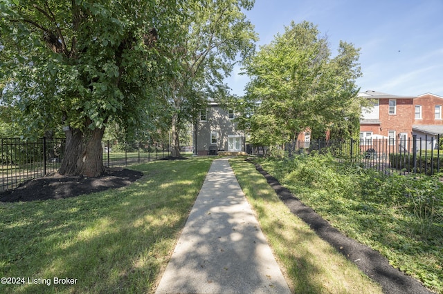 view of home's community with a yard