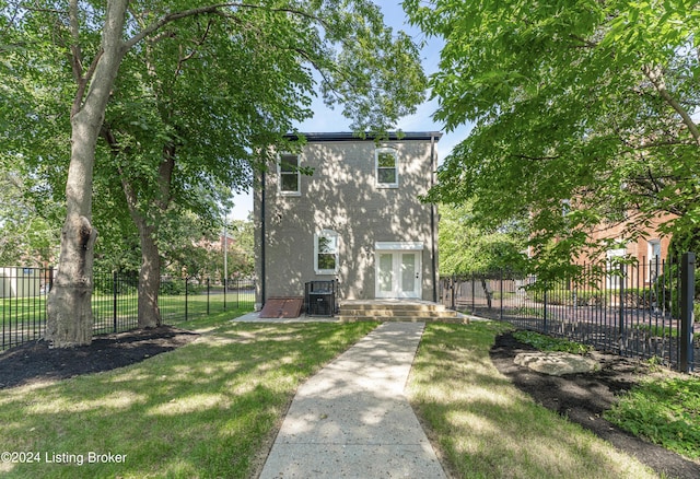 view of front of house featuring central AC and a front lawn