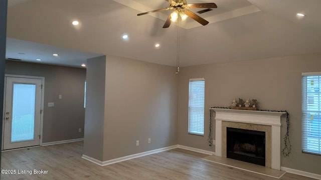 unfurnished living room featuring ceiling fan, light hardwood / wood-style flooring, and a healthy amount of sunlight