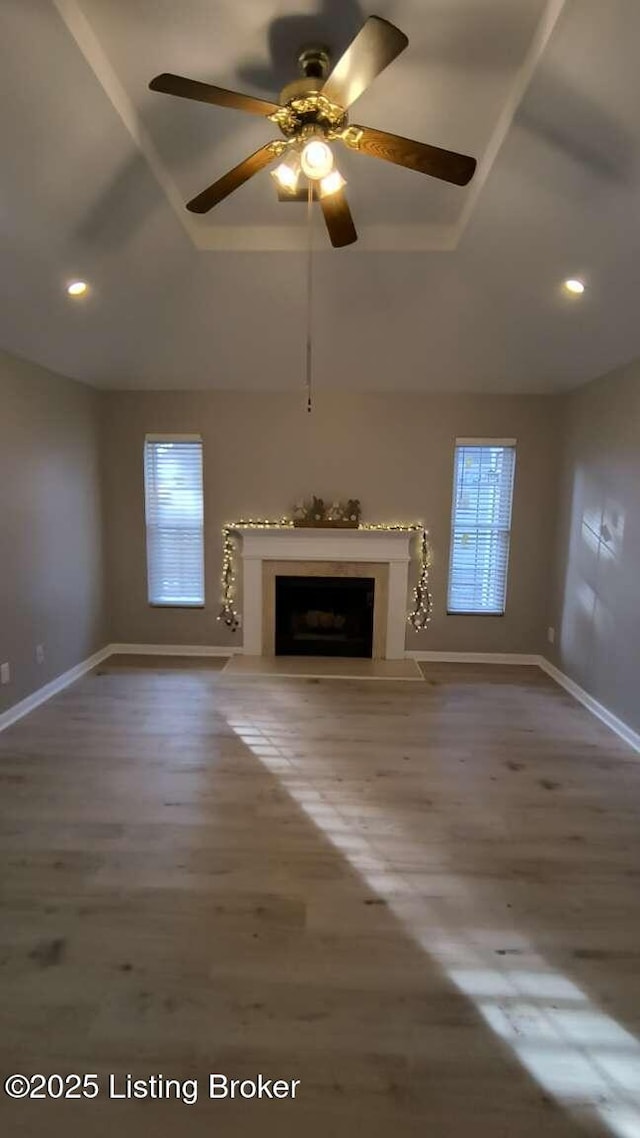 unfurnished living room featuring ceiling fan and wood-type flooring