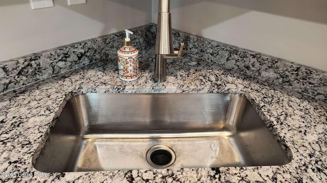 interior details featuring dark stone counters and sink