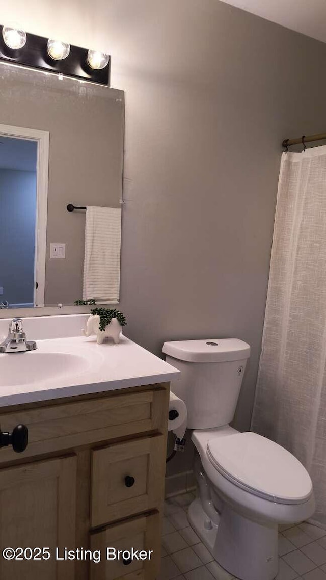 bathroom featuring a shower with curtain, tile patterned floors, toilet, and vanity