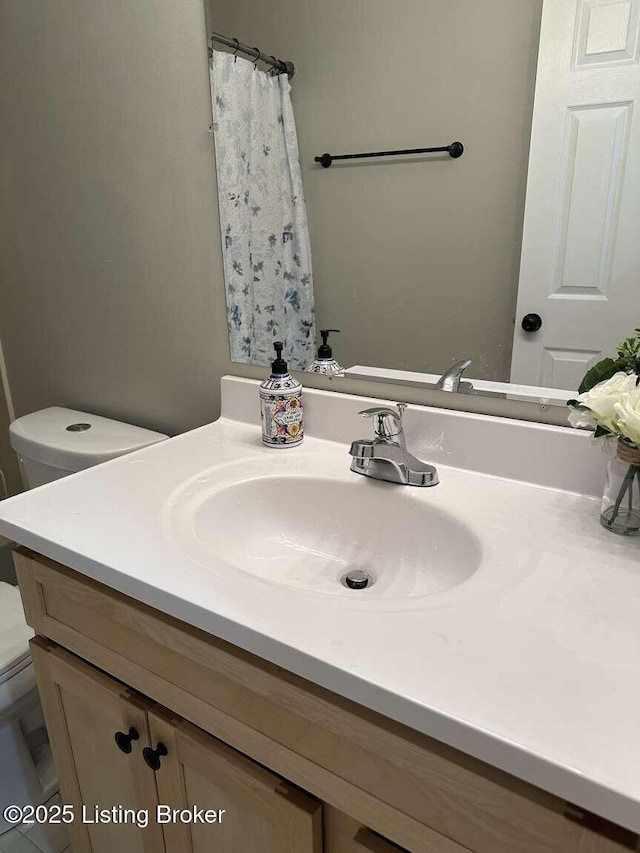 bathroom with vanity and toilet