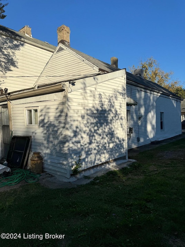 view of side of home featuring a yard