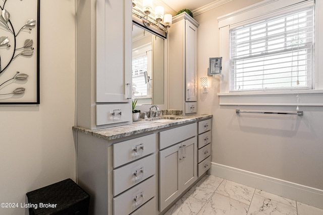 bathroom with ornamental molding and vanity