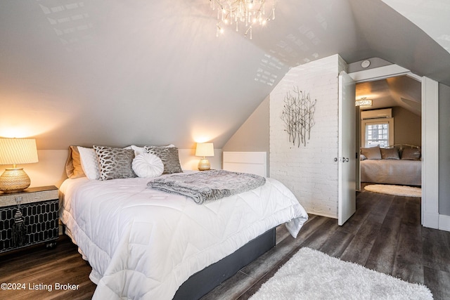 bedroom with vaulted ceiling, dark wood-type flooring, and a wall mounted AC