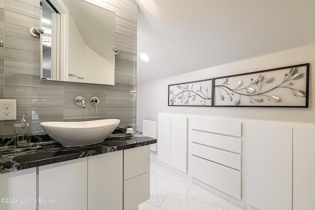 bathroom featuring tasteful backsplash and vanity