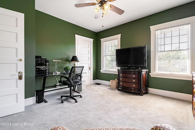 home office with light carpet and ceiling fan