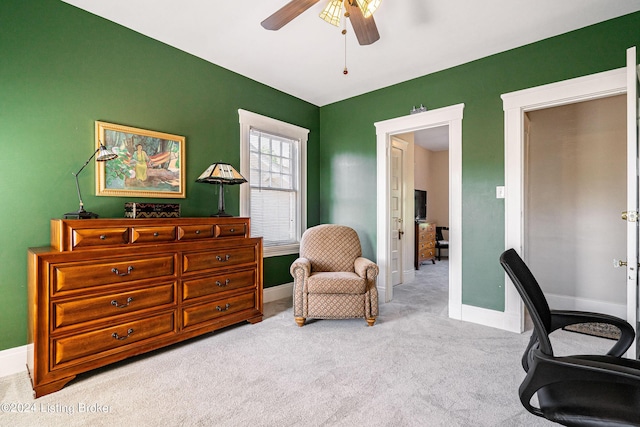 carpeted office space featuring ceiling fan