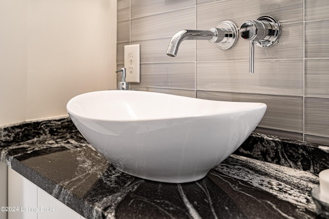 bathroom featuring sink and tile walls